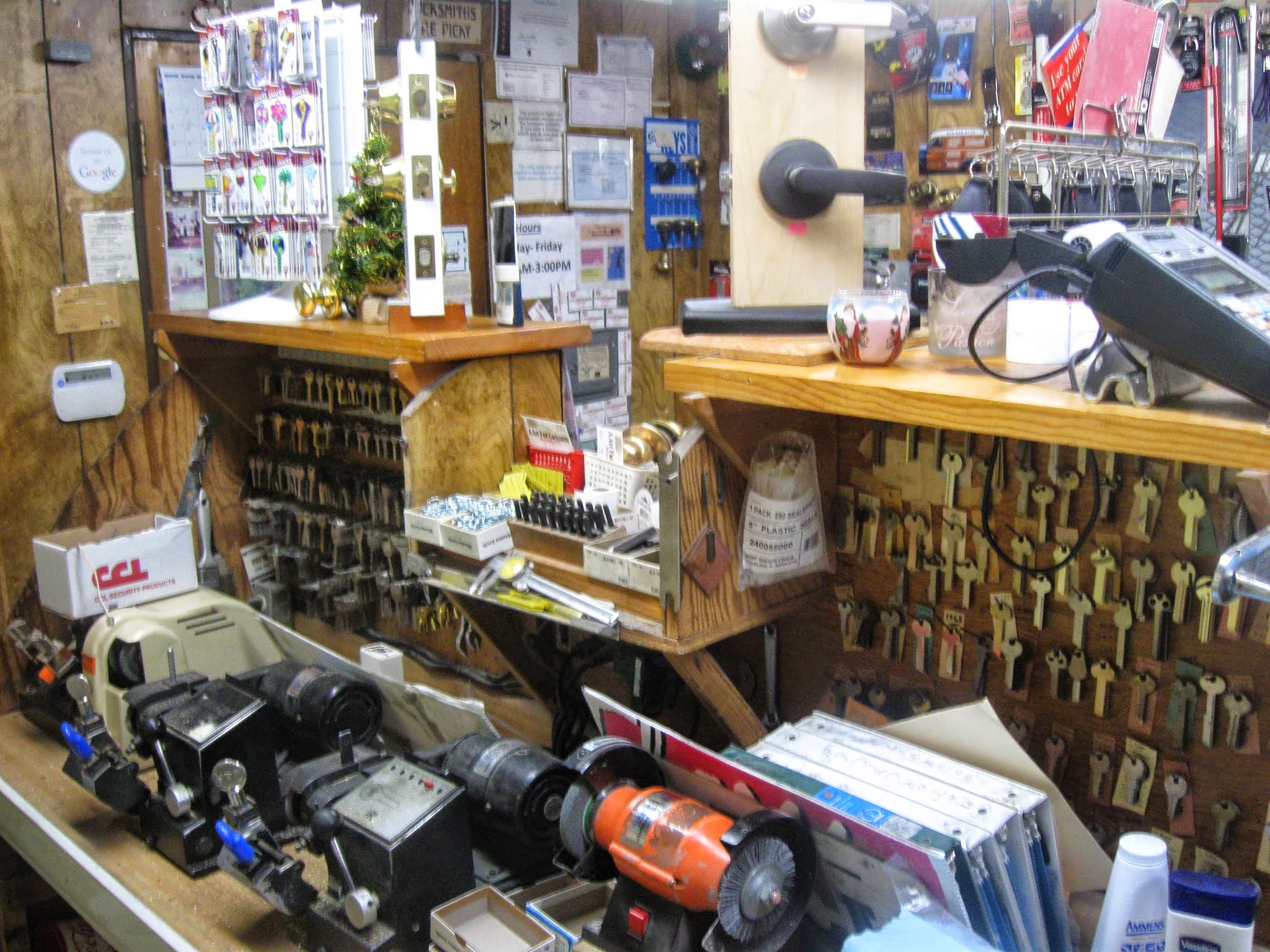 Key blanks and cutting machine inside A Act Fast Locksmith's workshop